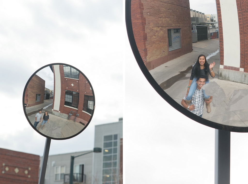 Urban engagement session in Denver, couple's reflection in a circular street mirror.
