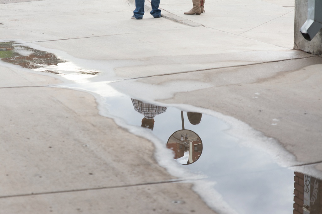 Couple's reflection in a puddle, urban engagement session
