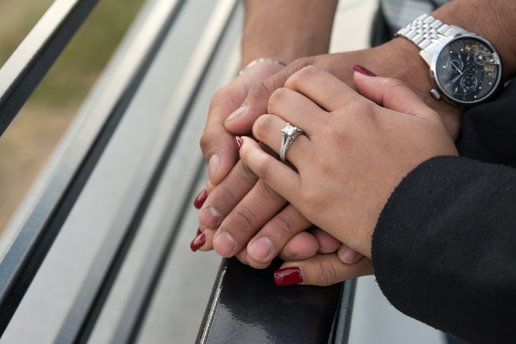 Couple holding hands to show off ring