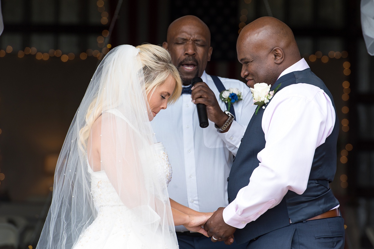 Bride and groom giggling during the prayer, Colorado wedding photographer