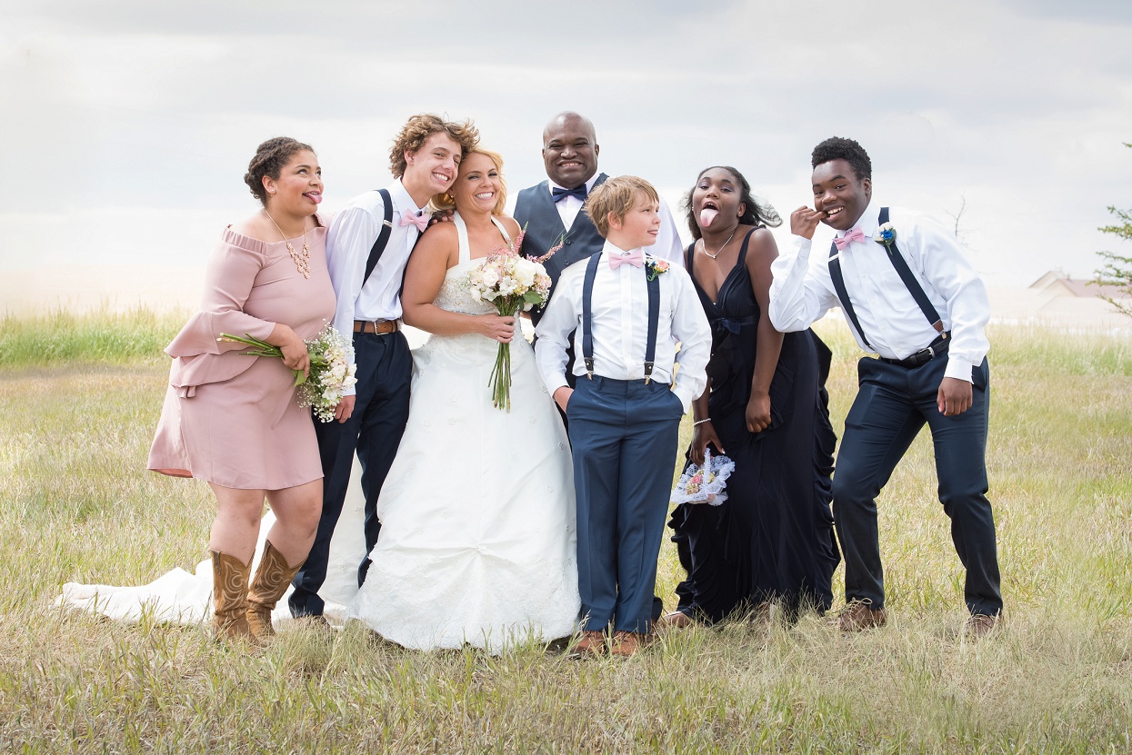 Silly photo of bride and groom with their teenage kids