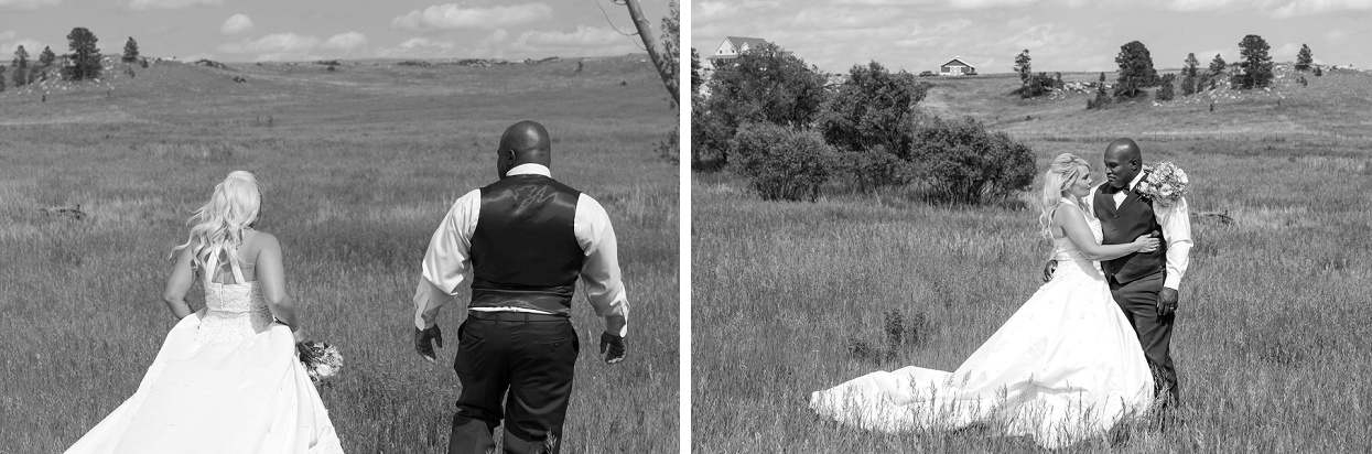 Black and white shot of bride and groom in a field, walking away from camera