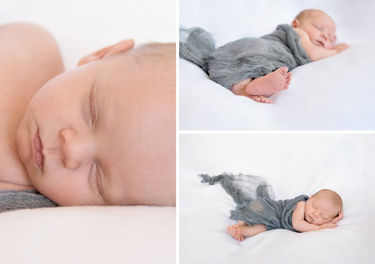 Baby on white backdrop wrapped in grey cheesecloth