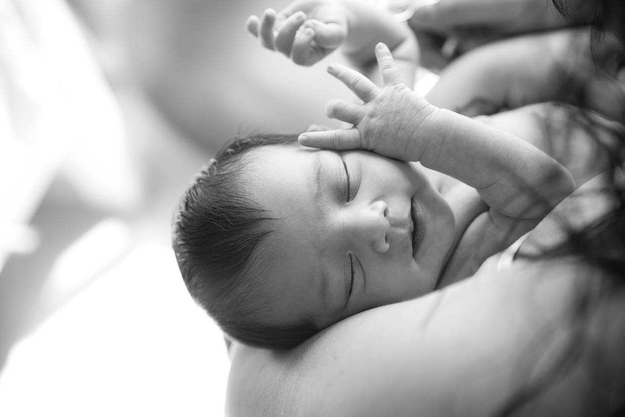 Artistic Denver newborn photography, baby falls asleep with hands up