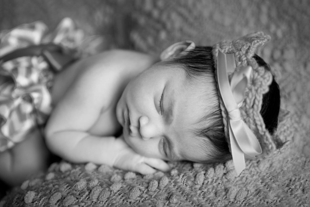 Black and white photo of baby with a crown