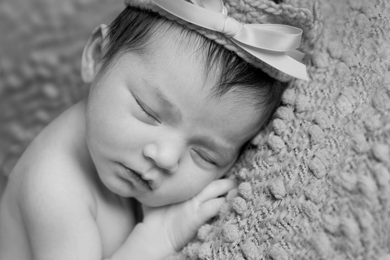 Dark haired baby in a crown, black and white newborn photography