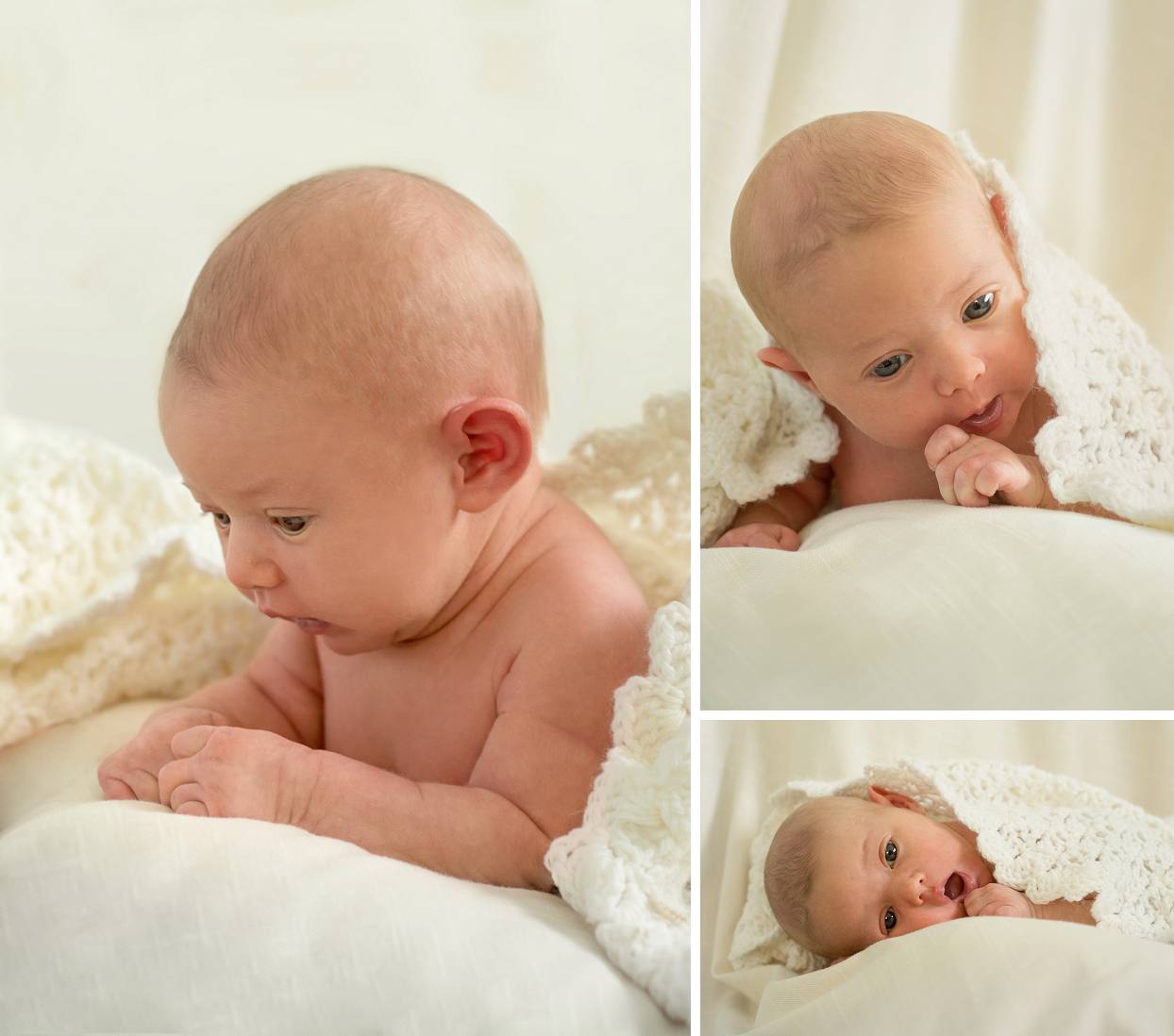 Newborn holding head up with blanket on top 