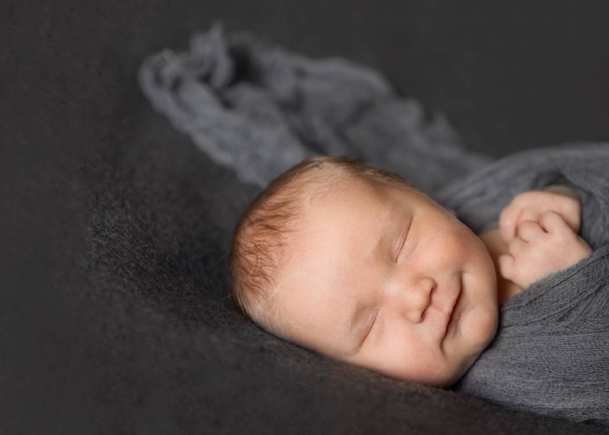 Greeley newborn photography on a charcoal grey backdrop