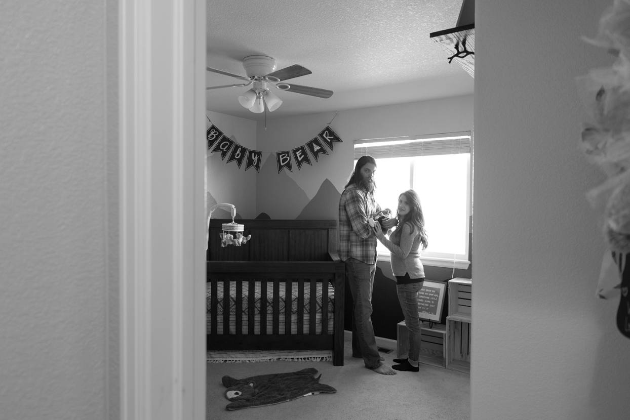 Looking into the nursery with parents holding baby, Colorado lifestyle photography