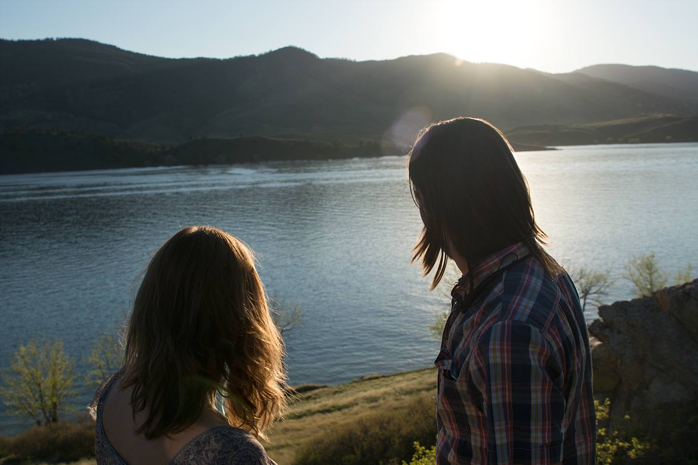 Sunset at Horsetooth Reservoir with couple in the foreground of lake