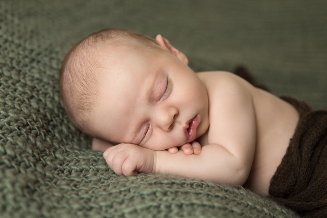 Newborn photography baby boy on a sage green backdrop