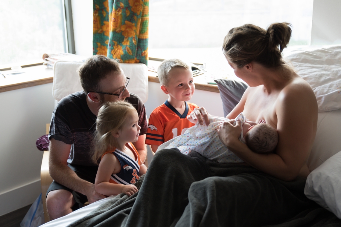 Children meeting new baby at birth center of Boulder