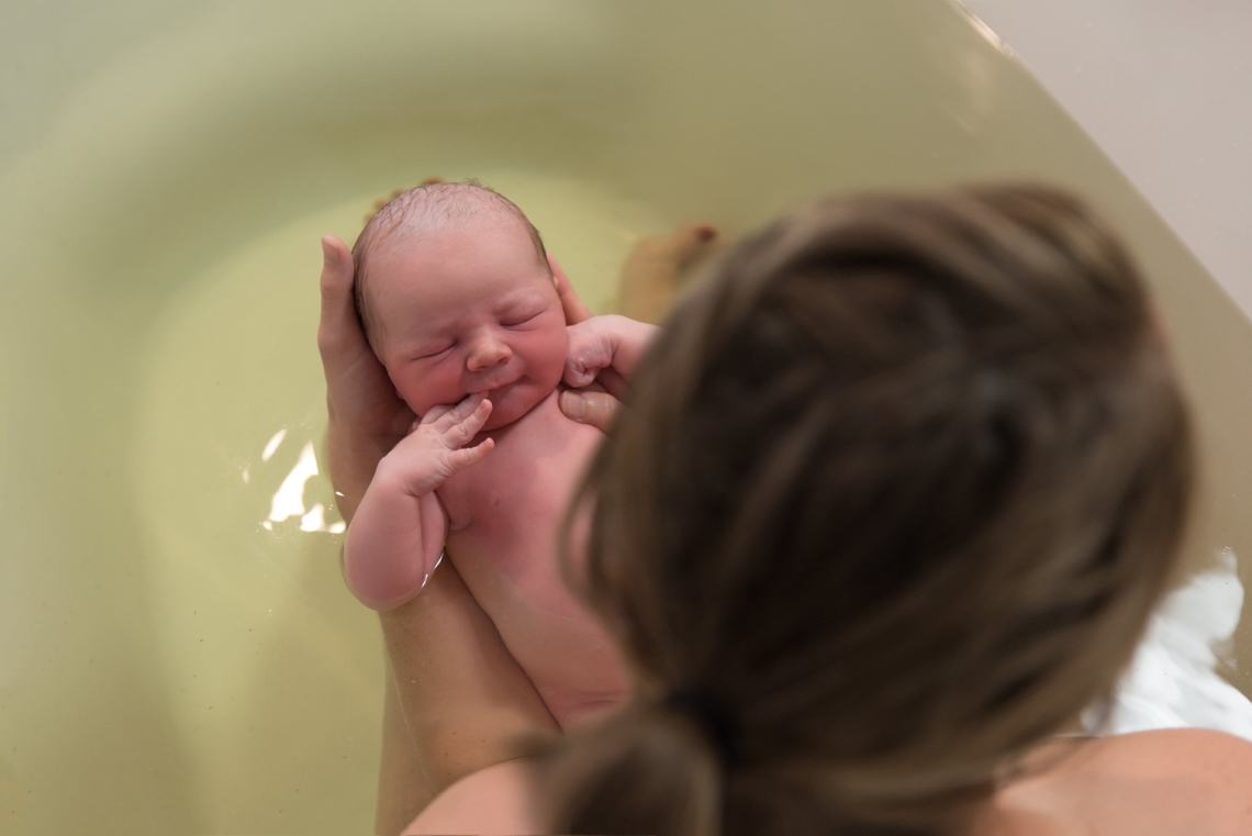 Newborn and mother in an herbal bath