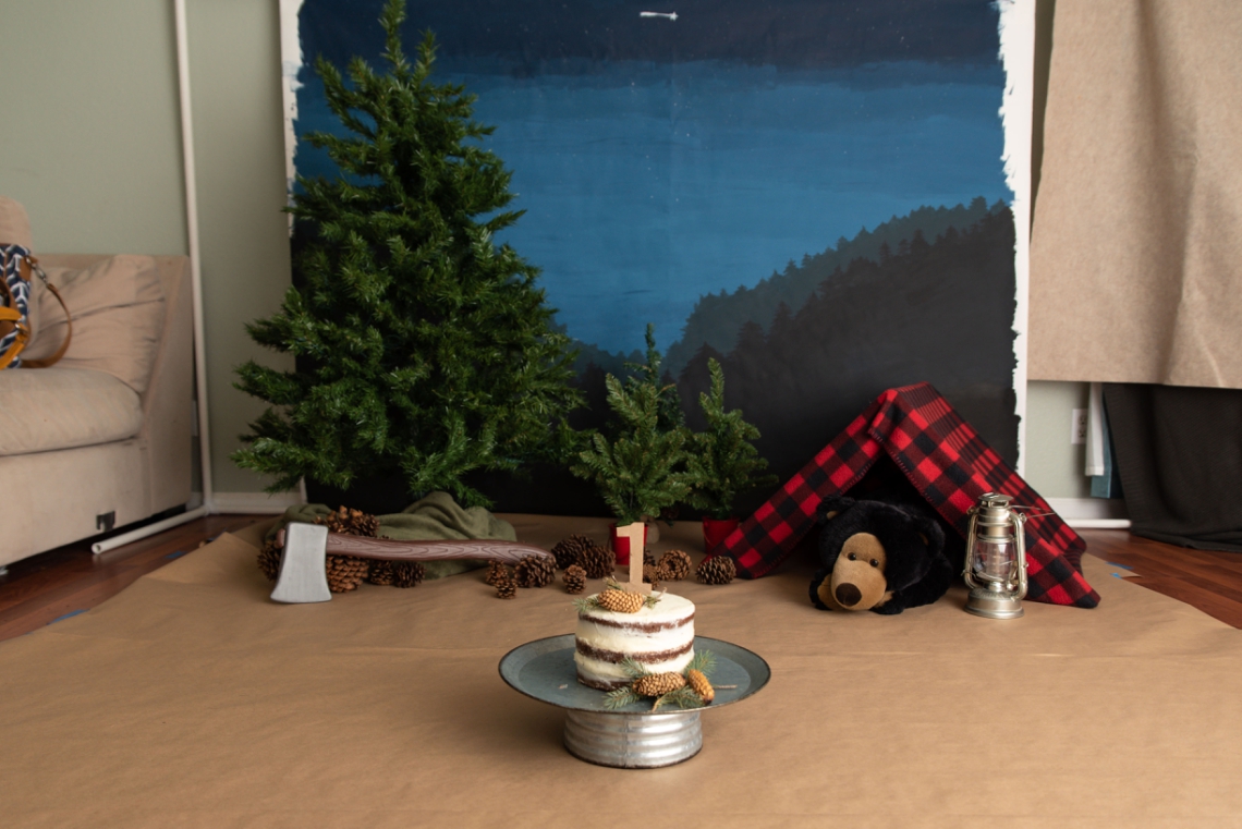 Lumberjack theme cake smash setup with starry might forest backdrop