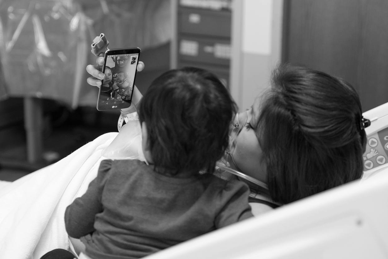 Video call during labor, hospital birth photography at Denver Health