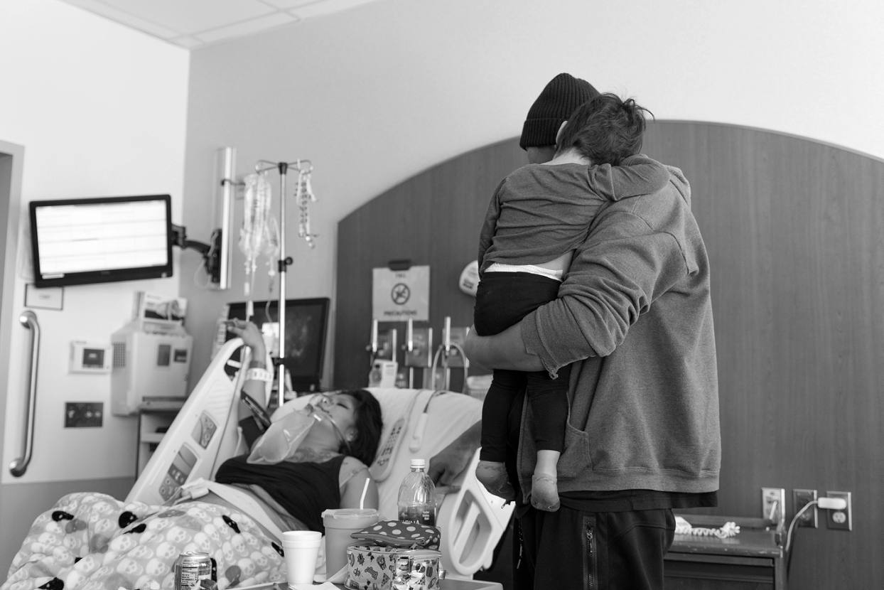 Father and child watching mom labor in the hospital