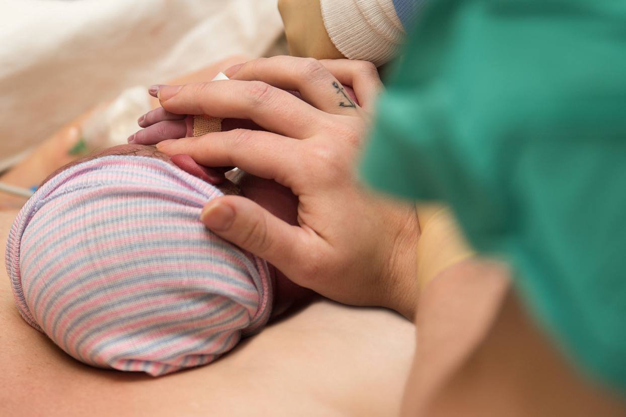 Mom holding baby's hand, birth photography