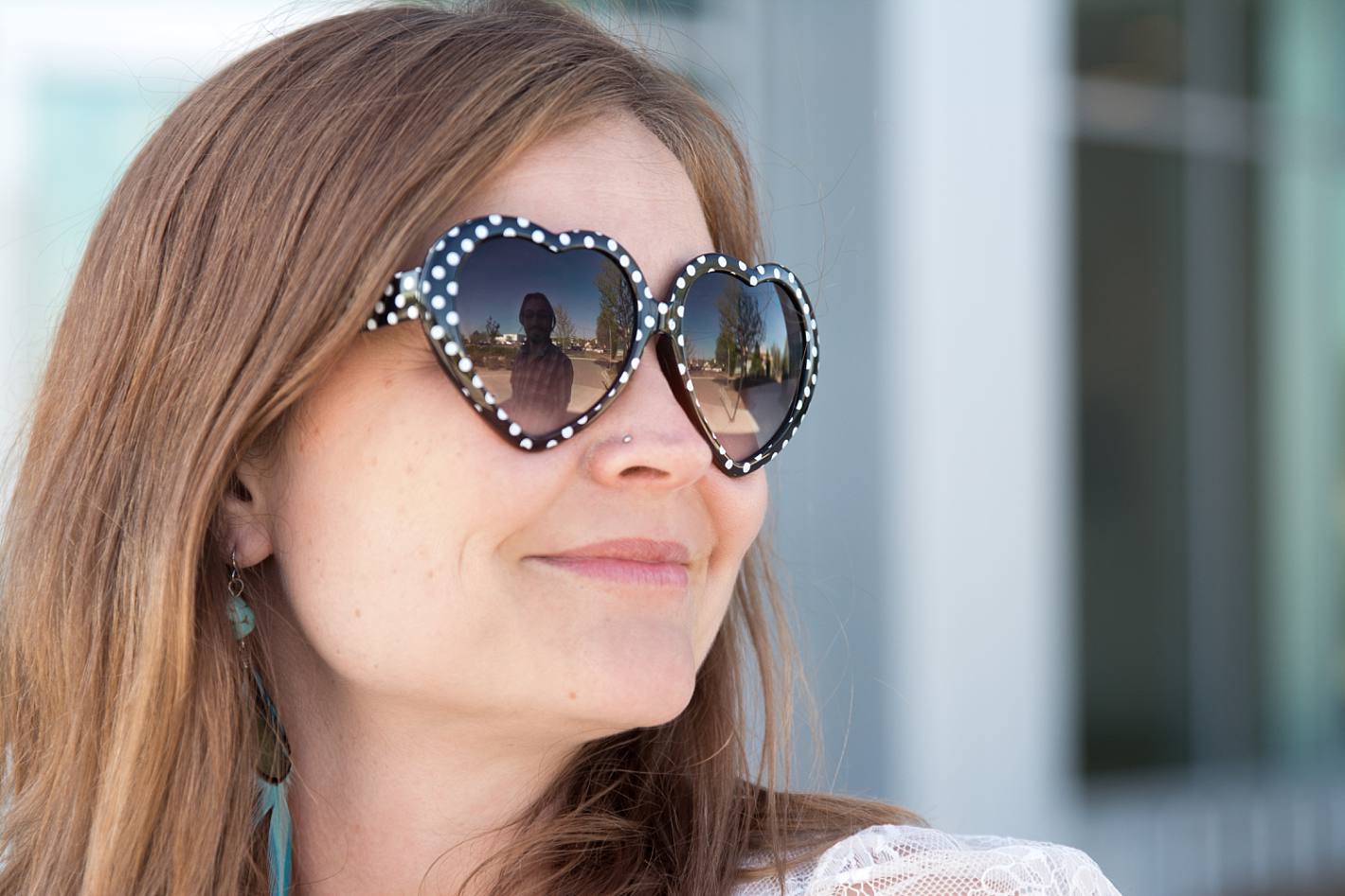 Polka dot heart shaped sunglasses, reflection of husband