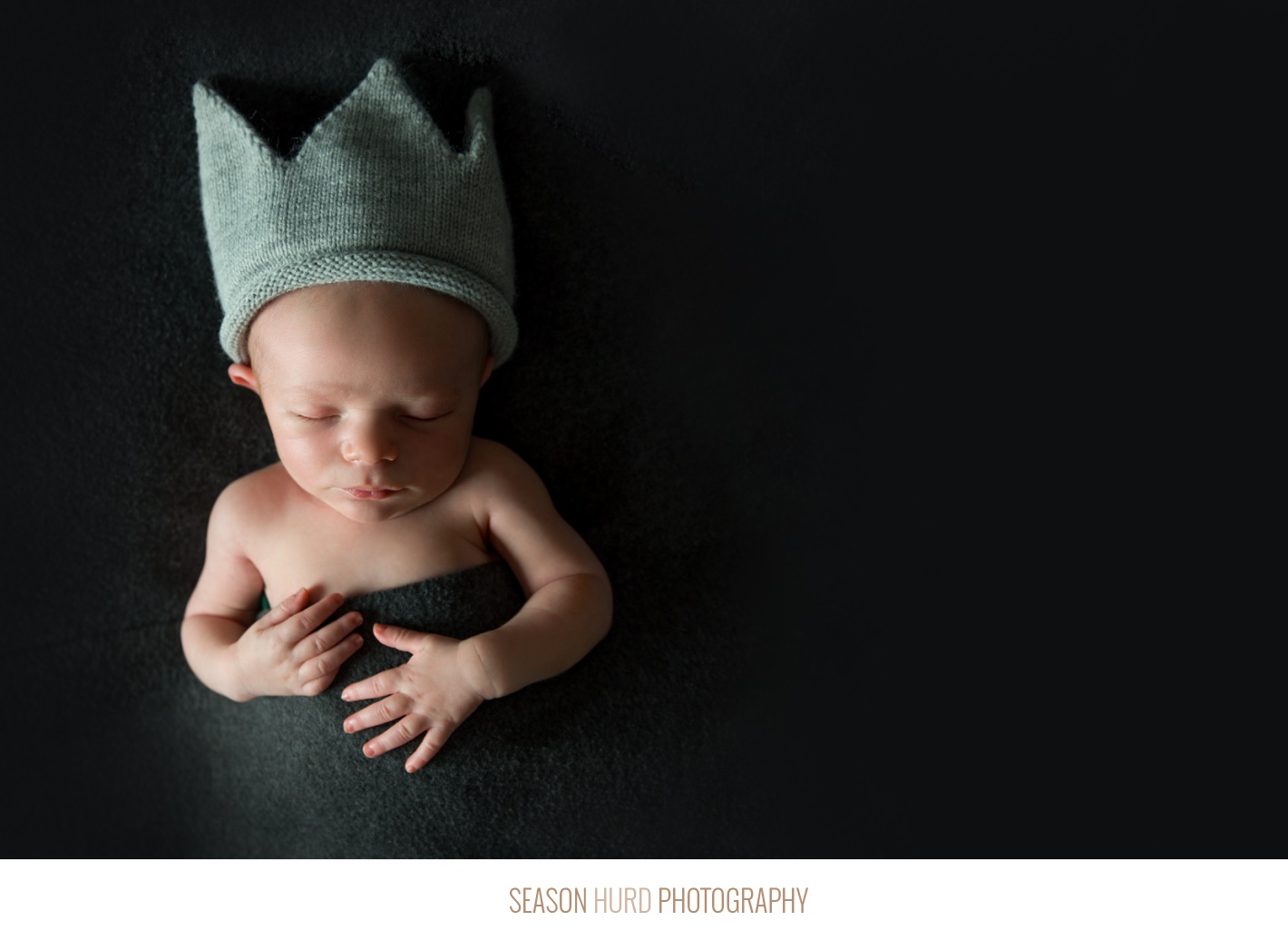 Newborn in grey crochet king's crown, low key newborn photography